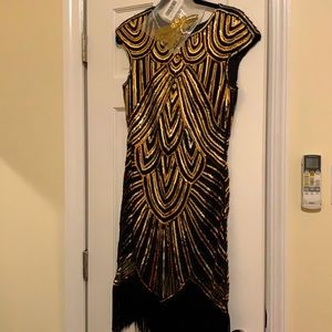 Gold and black flapper style dress. With gold headband.